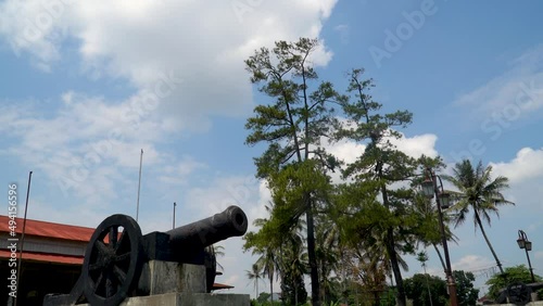 Old cannon from Dutch colonial era in Indonesia, pan down from sky photo