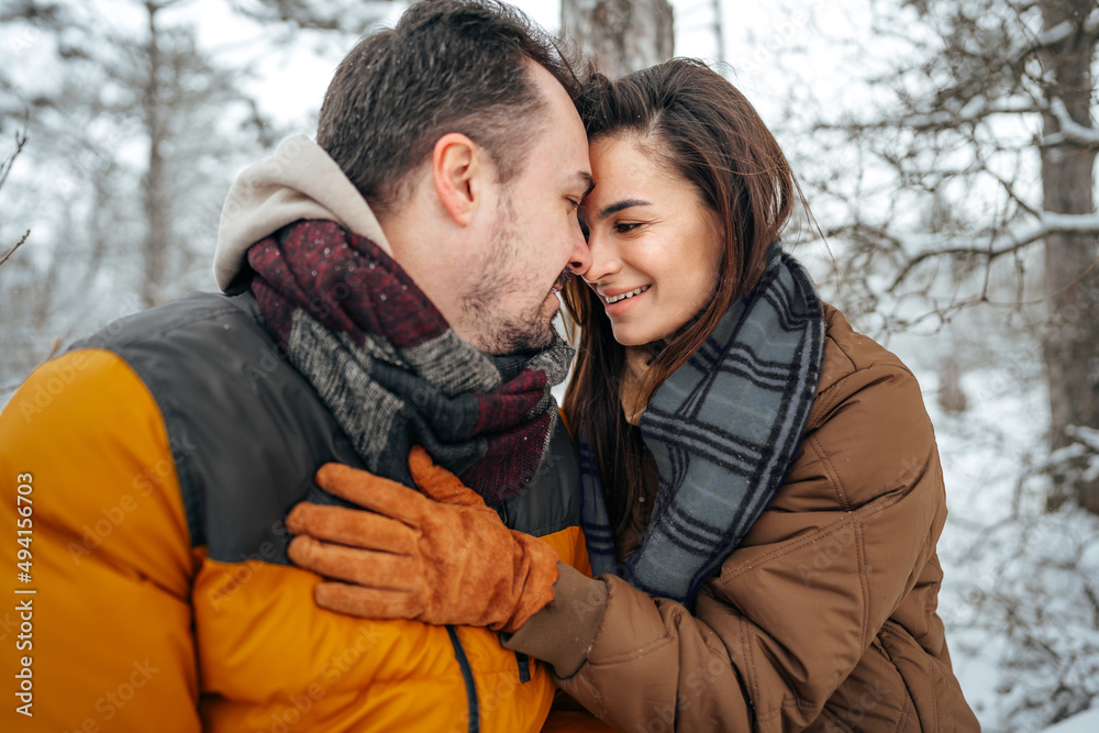 Young couple in love outdoor in snowy winter forest. Young couple in love outdoor in snowy winter forest.