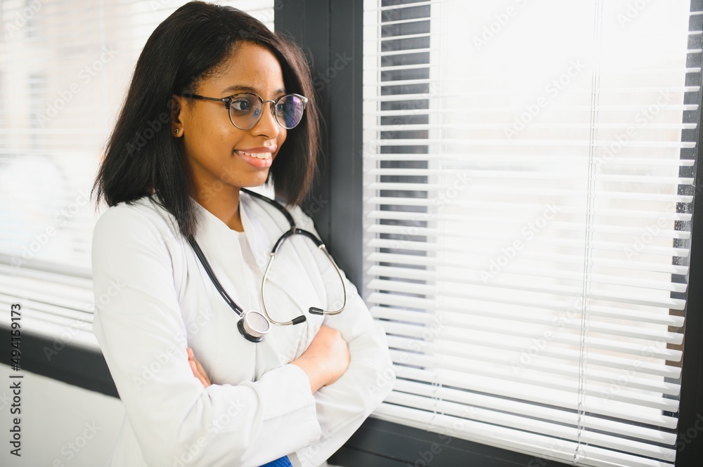 Portrait Of Smiling Female Doctor Wearing White Coat With Stethoscope In Hospital Office Portrait Of Smiling Female Doctor Wearing White Coat With Stethoscope In Hospital Office