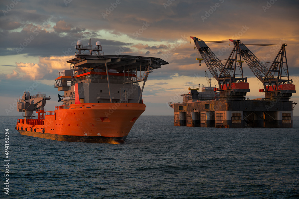 Oil rigs at sea during sunset