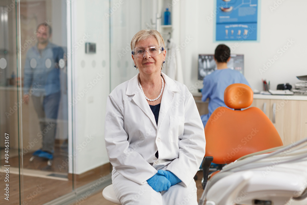 Obraz premium Portrait of specialist orthodontist doctor working in stomatological hospital office room waiting for sick patient to start tooth examination. Medical team working at healthcare treatment. Medicine