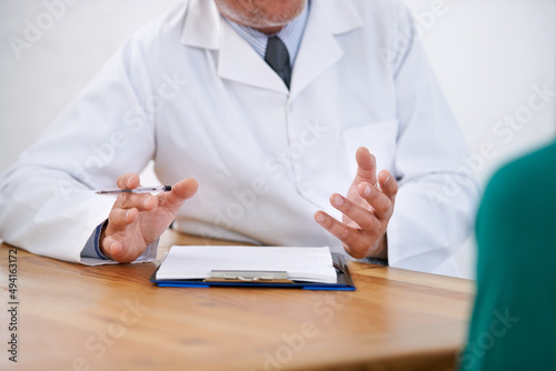Facts help to make informed decisions. Cropped shot of a doctor explaining something to his patient. photo