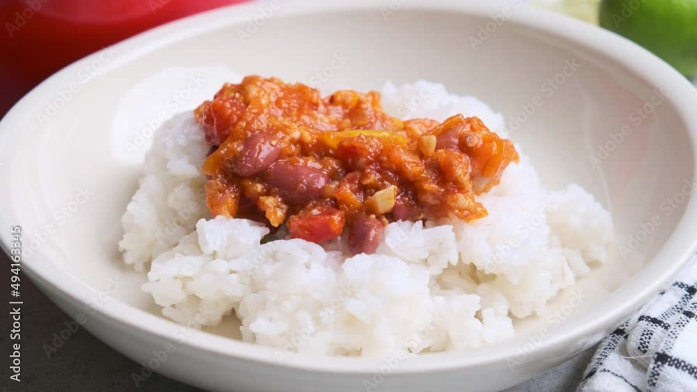 Vegan chili con carne with vegetables and beans in tomato sauce with rice in plate. Mexican food concept. Vegan chili con carne with vegetables and beans in tomato sauce with rice in plate. Mexican food concept.