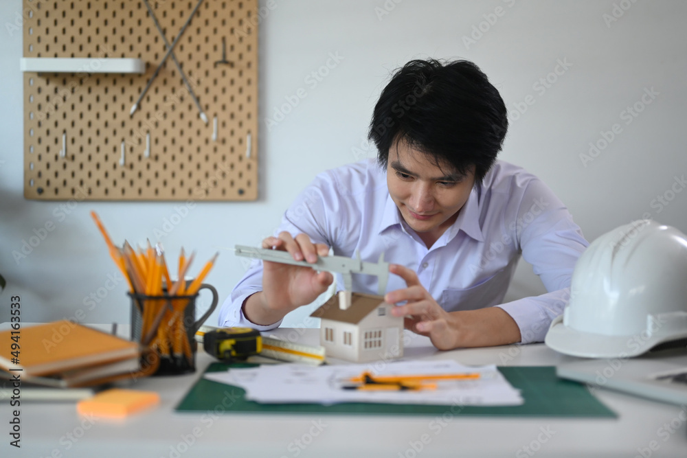 Experienced architect man working on architectural project at office. Experienced architect man working on architectural project at office.