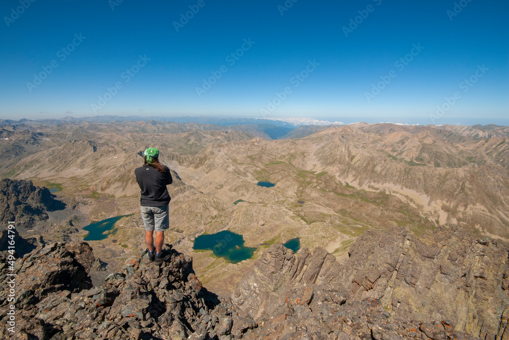A person watching the view from the top of the mountain. Watching the valley from the summit of Mount Verçenik. Looking over the valley from the top of the mountain. Kaçkar Mountains, Verçenik Plateau