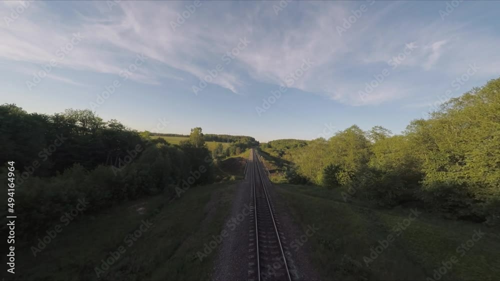 Flying over the bridge and the river on a drone. Flying along the railway rails. Flight at sunset. A sunny summer day. Aerial photography . FPV flights. High-speed flights on a drone. Flying over the bridge and the river on a drone. Flying along the railway rails. Flight at sunset. A sunny summer day. Aerial photography . FPV flights. High-speed flights on a drone.