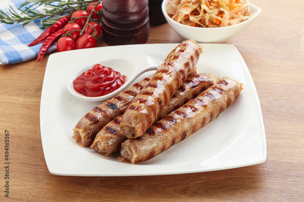 Grilled sausages with cabbage and sauce