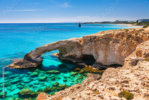 Fototapeta Naklejka Na Ścianę i Meble -  Beautiful natural rock arch near of Ayia Napa, Cavo Greco and Protaras on Cyprus island, Mediterranean Sea. Legendary bridge lovers. Amazing blue green sea and sunny day.