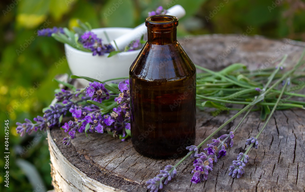 Herbal oil and lavender flowers on a wooden background. Nature. Herbal oil and lavender flowers on a wooden background. Nature.
