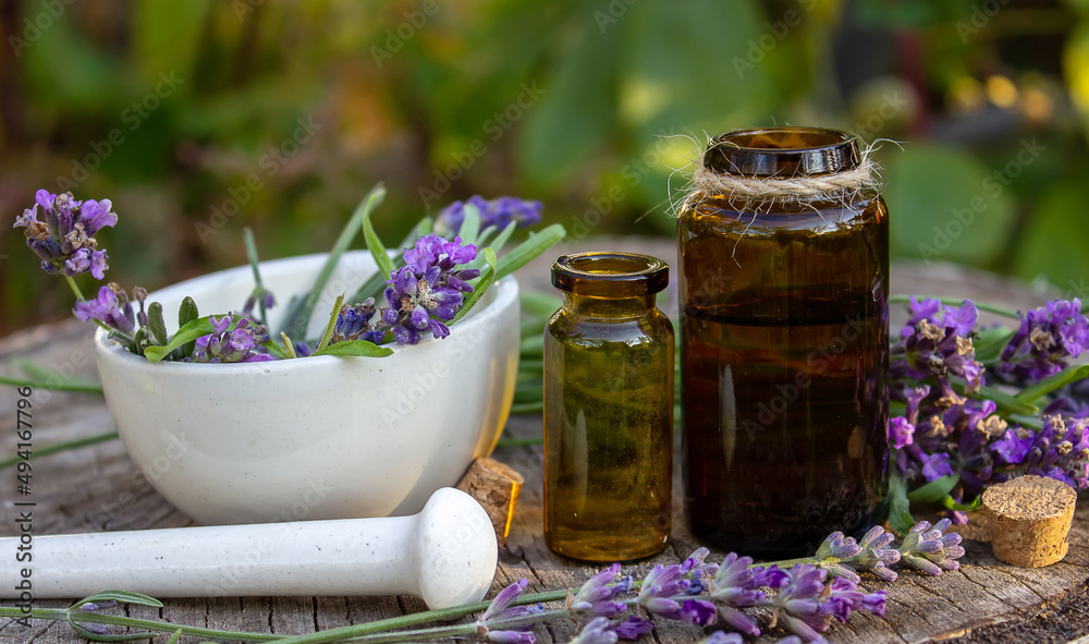Herbal oil and lavender flowers on a wooden background. Nature. Herbal oil and lavender flowers on a wooden background. Nature.
