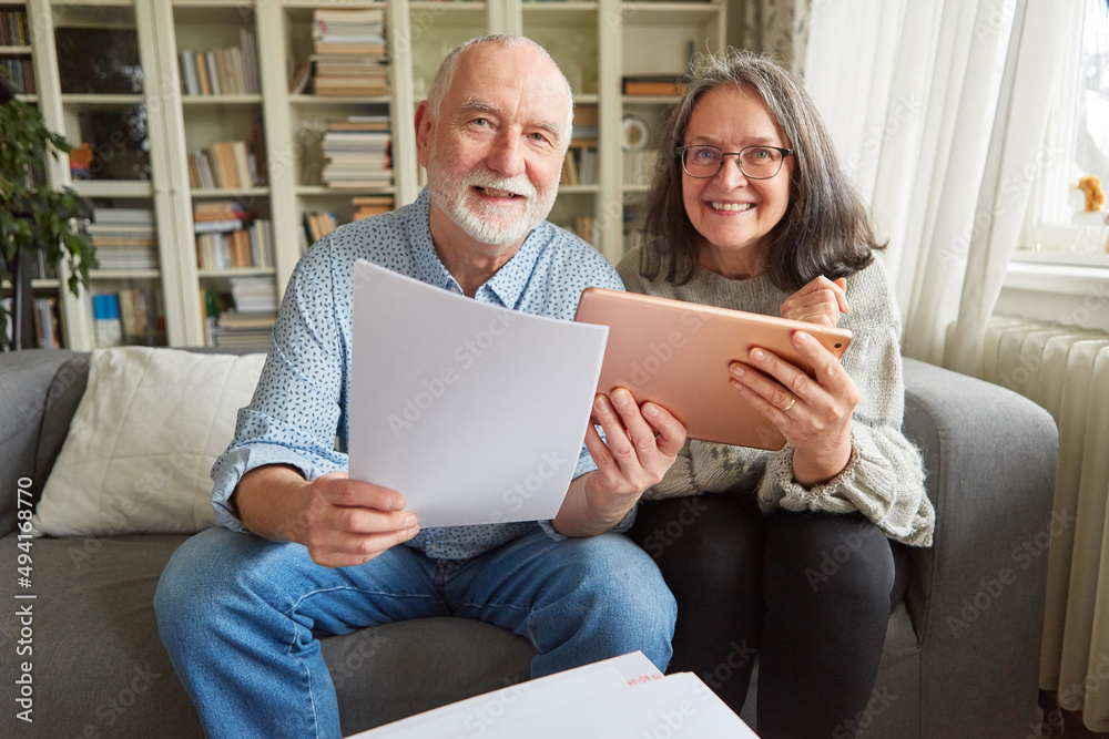 Happy couple of seniors using tablet computer online Happy couple of seniors using tablet computer online