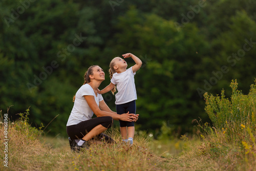 mother and daughter exercising outdoors