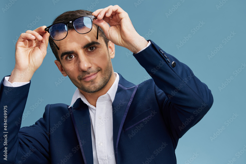 smart businessman puts on glasses blue suit emotions isolated background smart businessman puts on glasses blue suit emotions isolated background