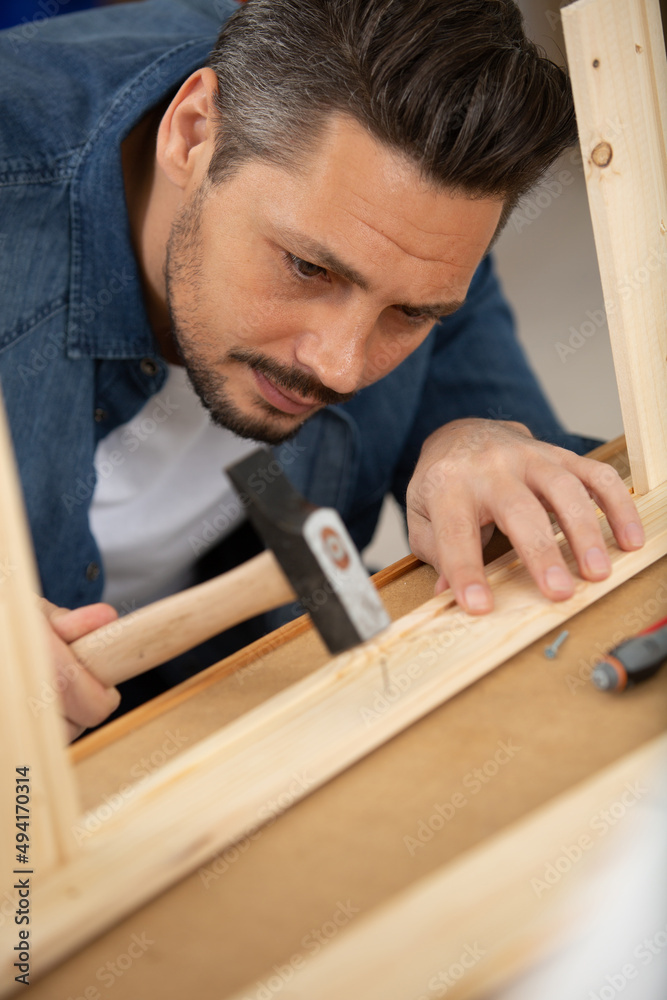 carpenter with hammer hitting nails carpenter with hammer hitting nails