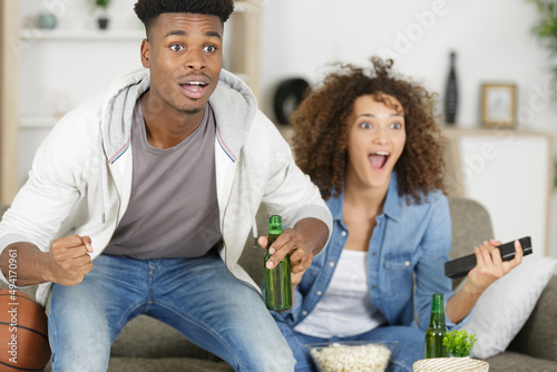 man watching americal football with his wife photo