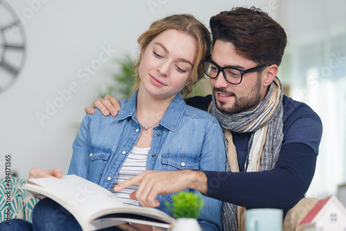a young couple reading book
