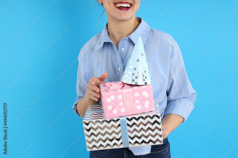 Concept of Happy Birthday with young woman on blue background Concept of Happy Birthday with young woman on blue background
