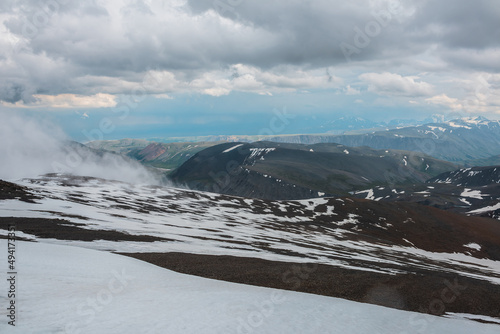 Wallpaper Mural Awesome top view to high mountains. Minimalist mountain landscape with low clouds. Dark atmospheric mountain scenery. Minimal alpine view from stone hill with snow and low clouds to mountain range. Torontodigital.ca
