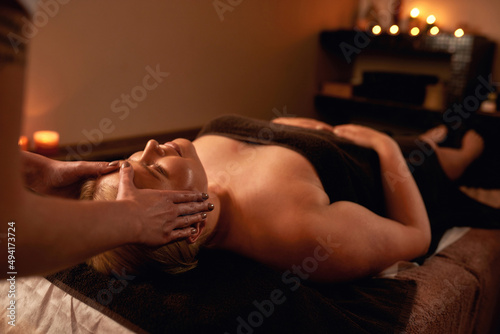 Cropped of masseur doing face massage of woman