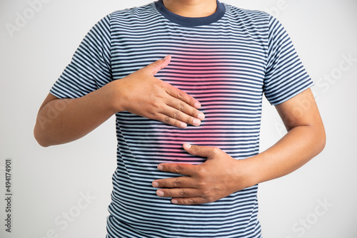 Man with acid reflux on white background, health care and diet concept. photo