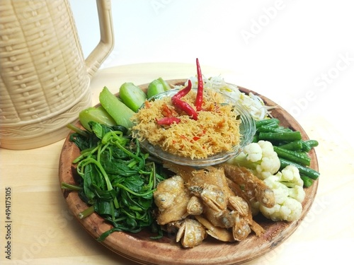 Urap is a traditional Indonesian dish in the form of cooked (boiled) vegetables mixed with seasoned grated coconut as a flavor enhancer photo