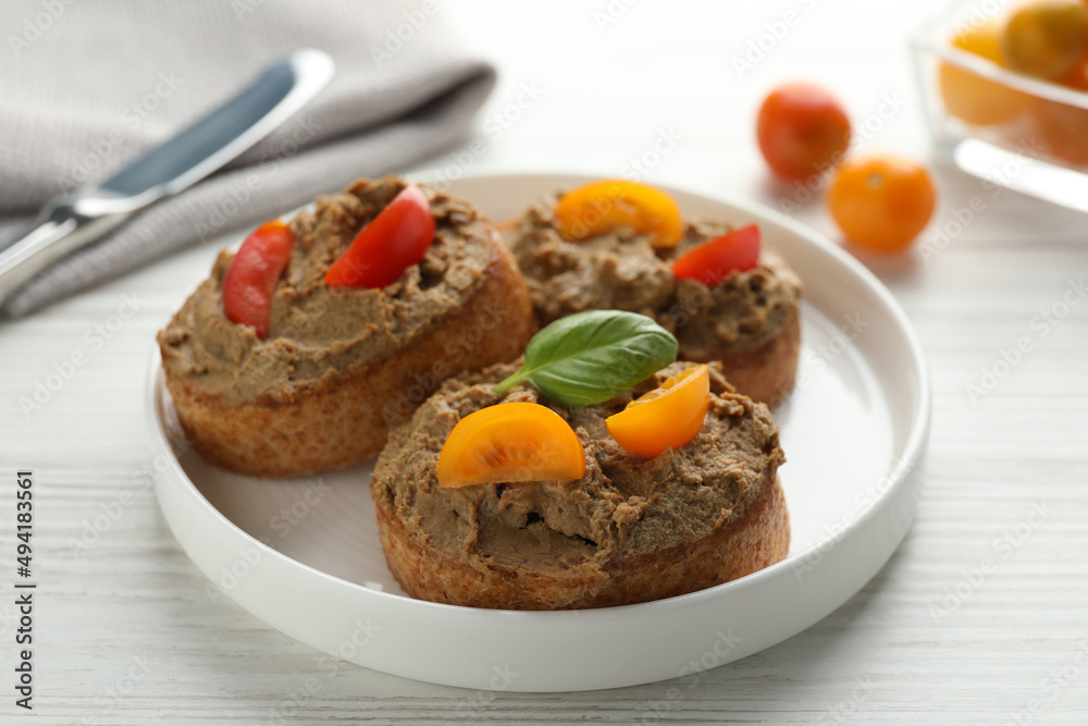 Slices of fresh bread with delicious pate and tomatoes on white wooden table, closeup Slices of fresh bread with delicious pate and tomatoes on white wooden table, closeup