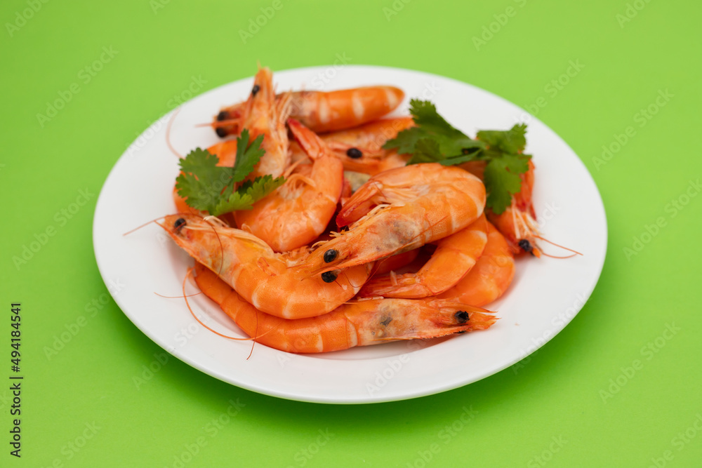 boiled fresh shrimps with parsley on white small dish