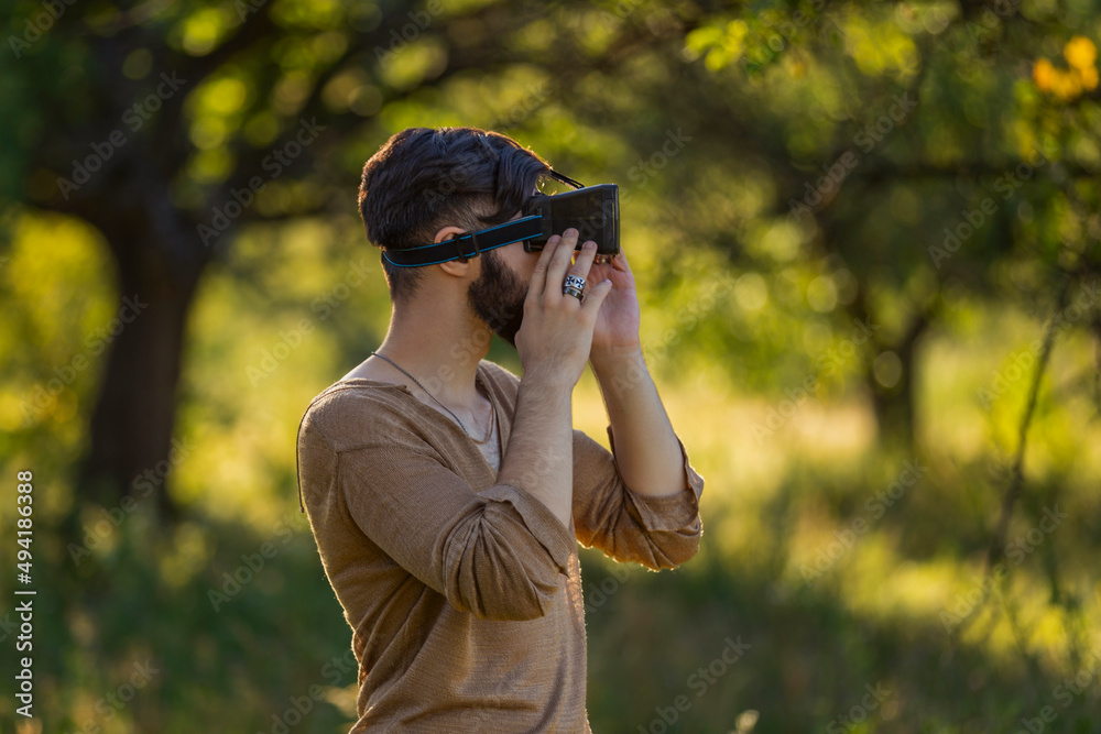 man wearing virtual reality glasses outdoors