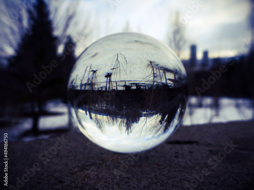 Evening Winter landscape seen through a lens ball.