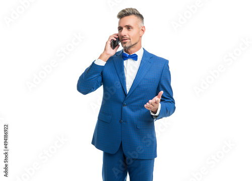 smiling man in blue bow tie suit talk on phone isolated on white