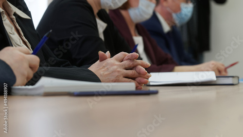 Hands of an elderly woman participating in a meeting or negotiations during the coronavirus pandemic. Age official, lawyer or businesswoman. Business and the coronavirus pandemic. No face