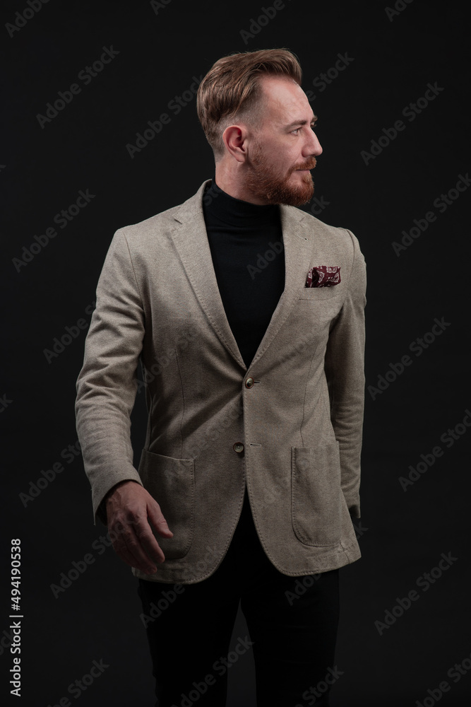 Confident businessman walking forward wearing a causal suit, handsome senior business man hero shot portrait isolated on black