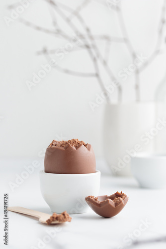 Chocolate easter egg in a white eggholder photo