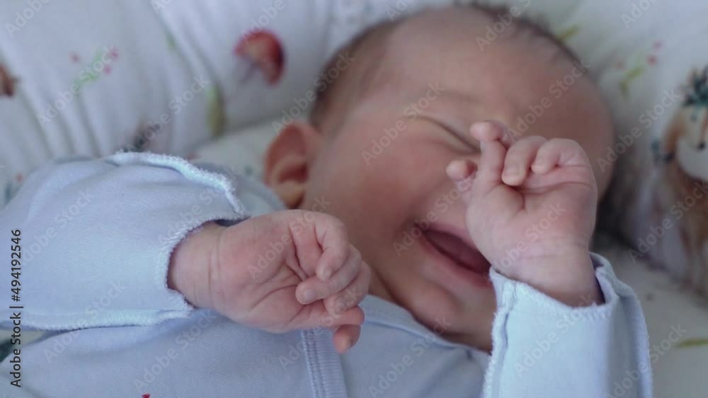 newborn baby boy in diaper lies in crib Video HD newborn baby boy in diaper lies in crib Video HD
