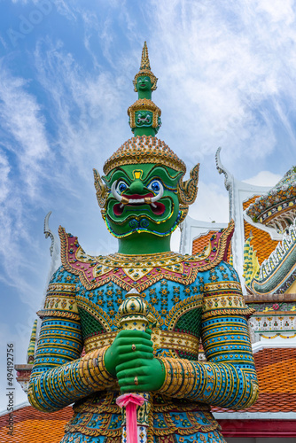 Giants front of the church at Wat Arun Temple. Wat Arun is among the best known of Thailand's landmarks. Wat Arun is a Buddhist temple in Bangkok Yai district of Bangkok, Thailand. photo