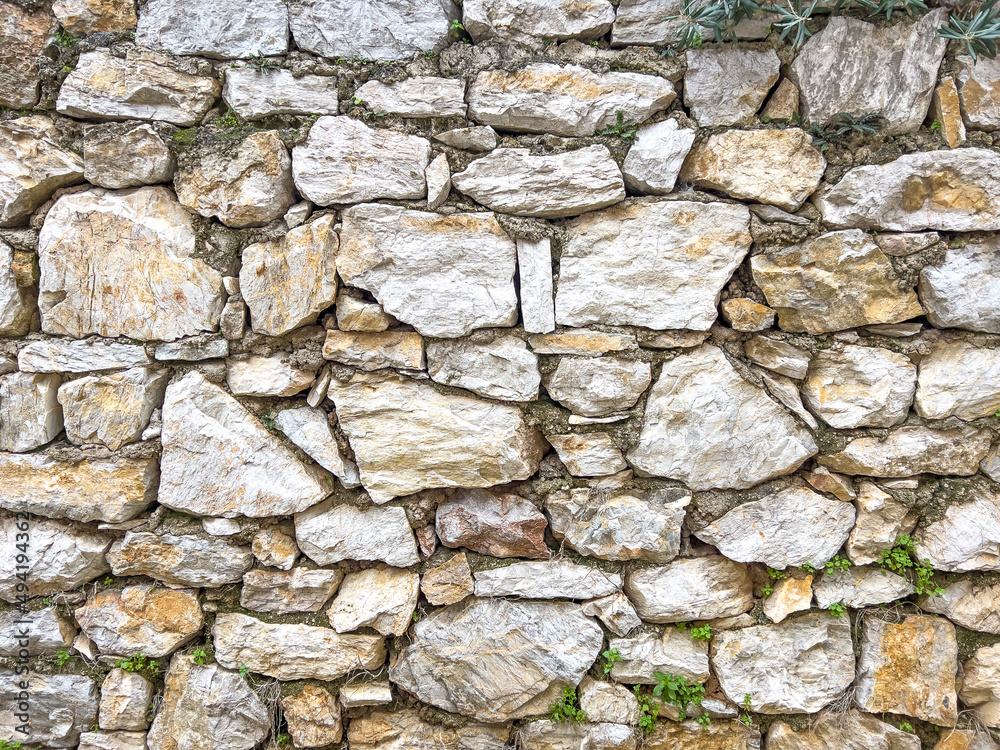 Stone wall texture. Part of old rocky hand crafted background with copy space. Walls made of natural bricks. High quality photo. Home and office design backdrop Stone wall texture. Part of old rocky hand crafted background with copy space. Walls made of natural bricks. High quality photo. Home and office design backdrop