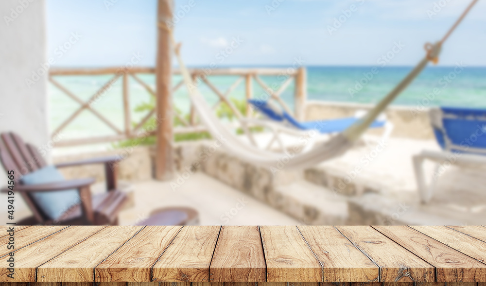 Obraz premium Empty wooden table with relaxing zone in the beach on background