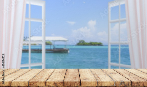 Empty wooden table with window in the beach on background 