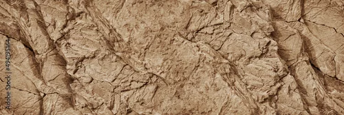 Panel kuchenny z motywem Light brown rock texture. Mountain rough surface. Close-up. Stone wall background with copy space for design. Wide banner. Panoramic.