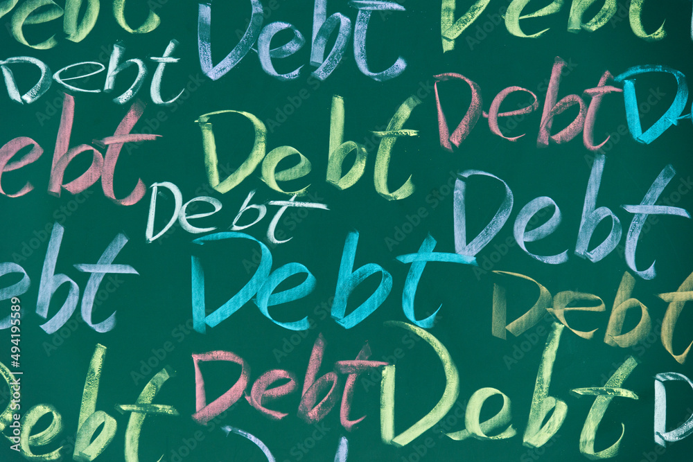 Many debt word written on chalkboard