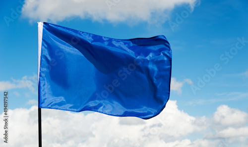 Blue flag waving on sky