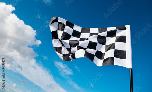 Checkered flag on blue sky