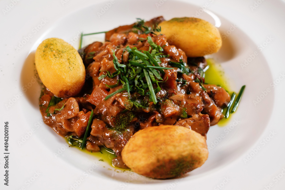 Minced meat with baked potatoes and vegetables.