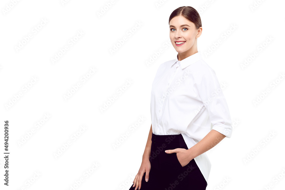 Young successful smiling woman in a white shirt on a white isolated background keeps her hands in her pockets Young successful smiling woman in a white shirt on a white isolated background keeps her hands in her pockets