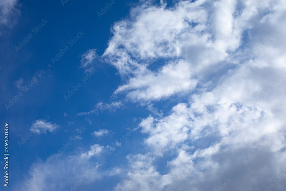 cloudscape with cirrus clouds on blue sky, natural background