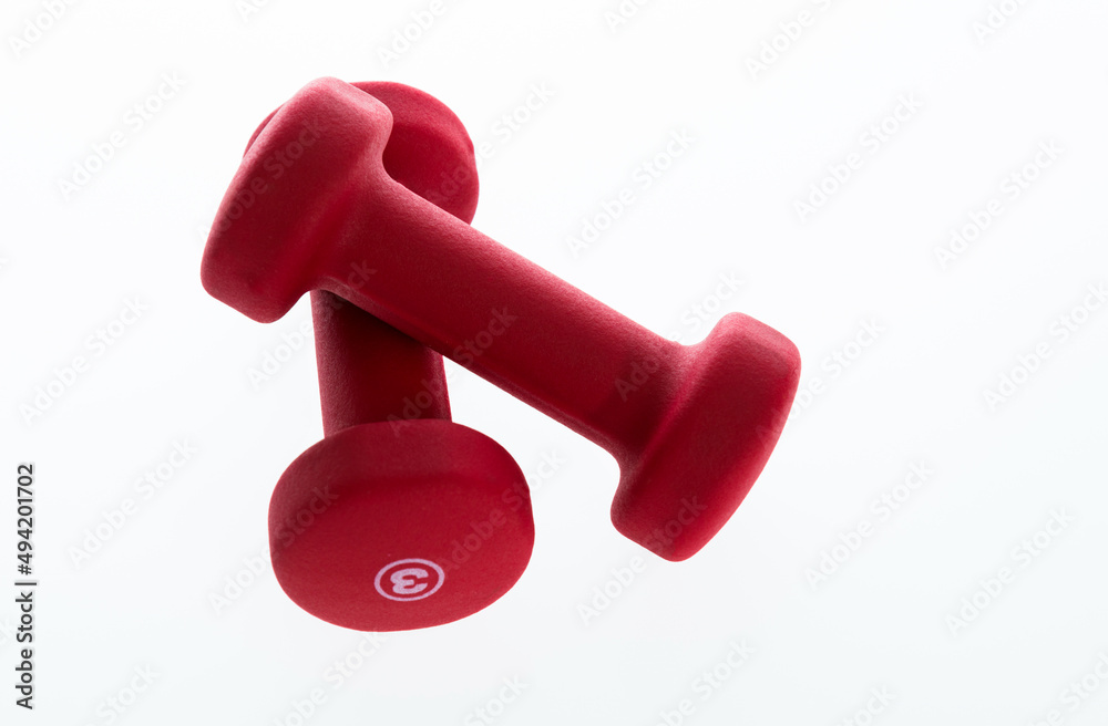 Pair of red dumbbells isolated on white Pair of red dumbbells isolated on white