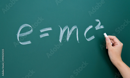 Naklejka Einstein equation emc2 handwritten chalk on blackboard