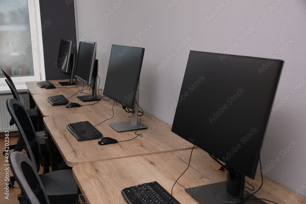 Naklejka premium Many modern computers in open space office