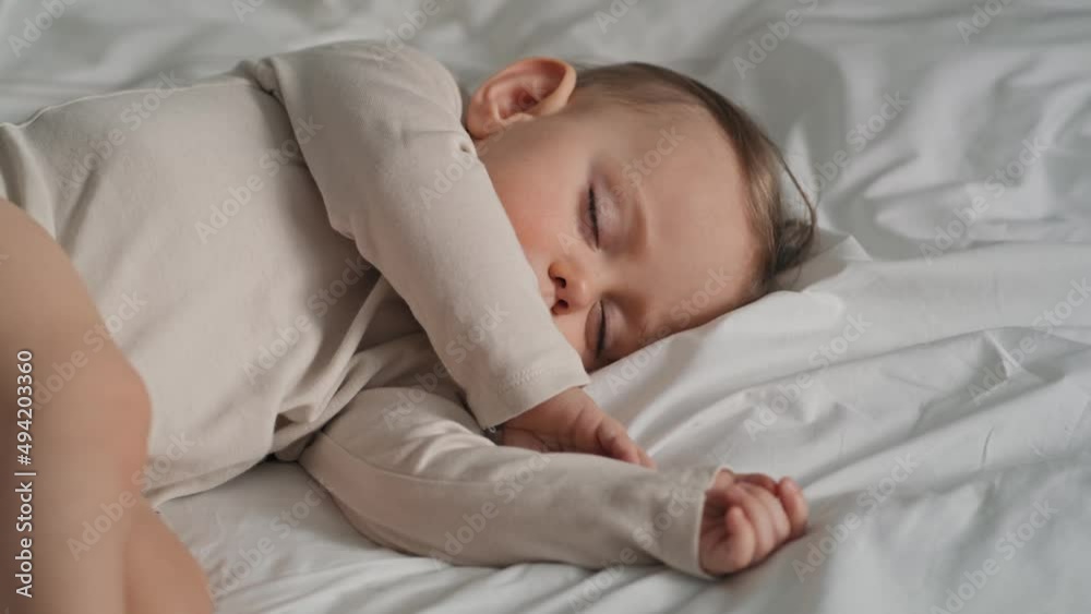 Video of caucasian little baby girl sleeping on bed at home. Shot with RED helium camera in 8K. Video of caucasian little baby girl sleeping on bed at home. Shot with RED helium camera in 8K.