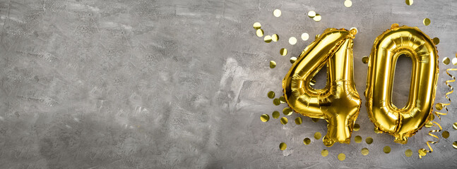 Yellow foil balloon number, number forty concrete background. Greeting card with the inscription 40. Anniversary concept. for anniversary, birthday, new year celebration. banner,